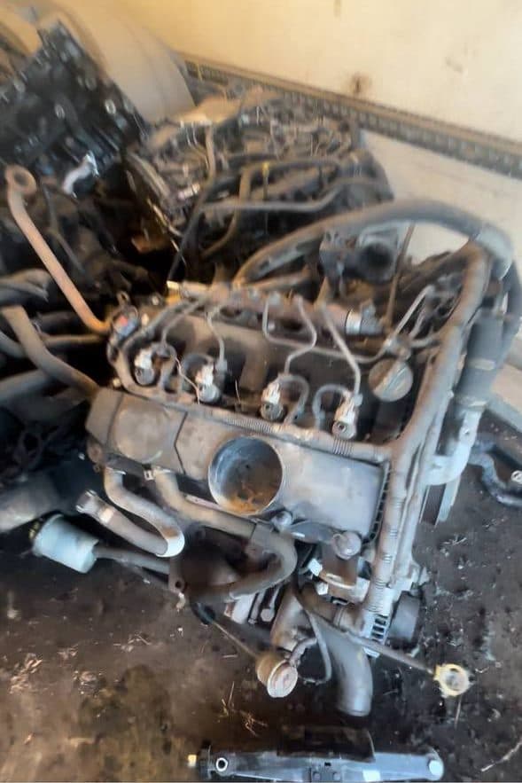 Removed diesel engines lined up on the floor of a unit
